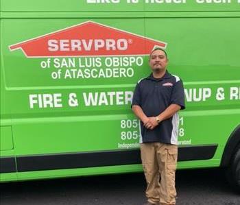 male SERVPRO employee in front of a green van