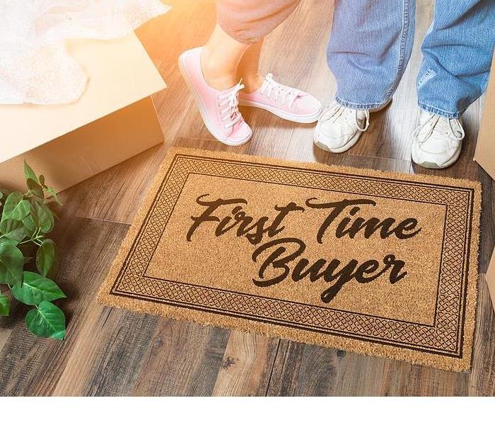 inside a house there is a door mat with first time buyer
