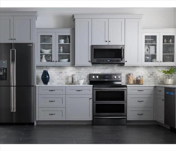 white cabinets in a kitchen with a fridge stove and dishwasher