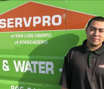 male with a SERVPRO black shirt of in front of a green van